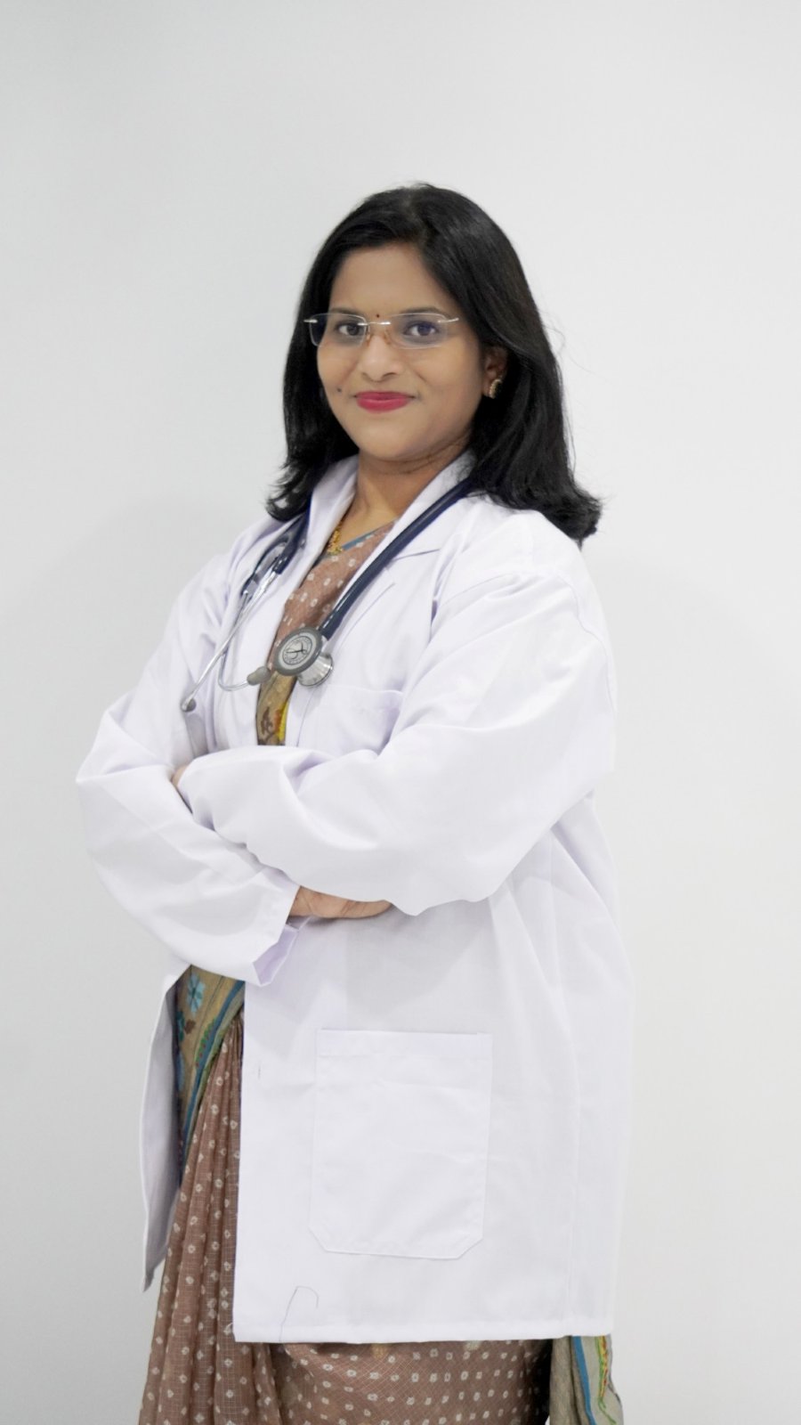 Dr Sarika Thakur in a white coat with a stethoscope
